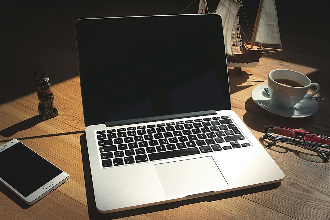 Smartphone and notebook on a work desk, representing after-hours digital work demands and recovery boundaries.