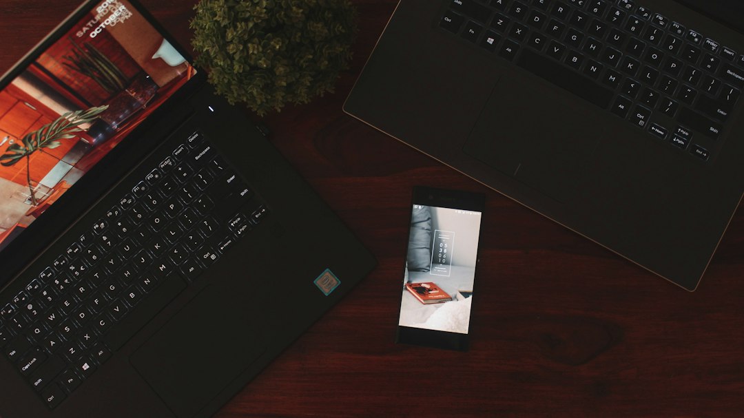 Professional working across devices, representing blurred boundaries between work demands and personal recovery time.