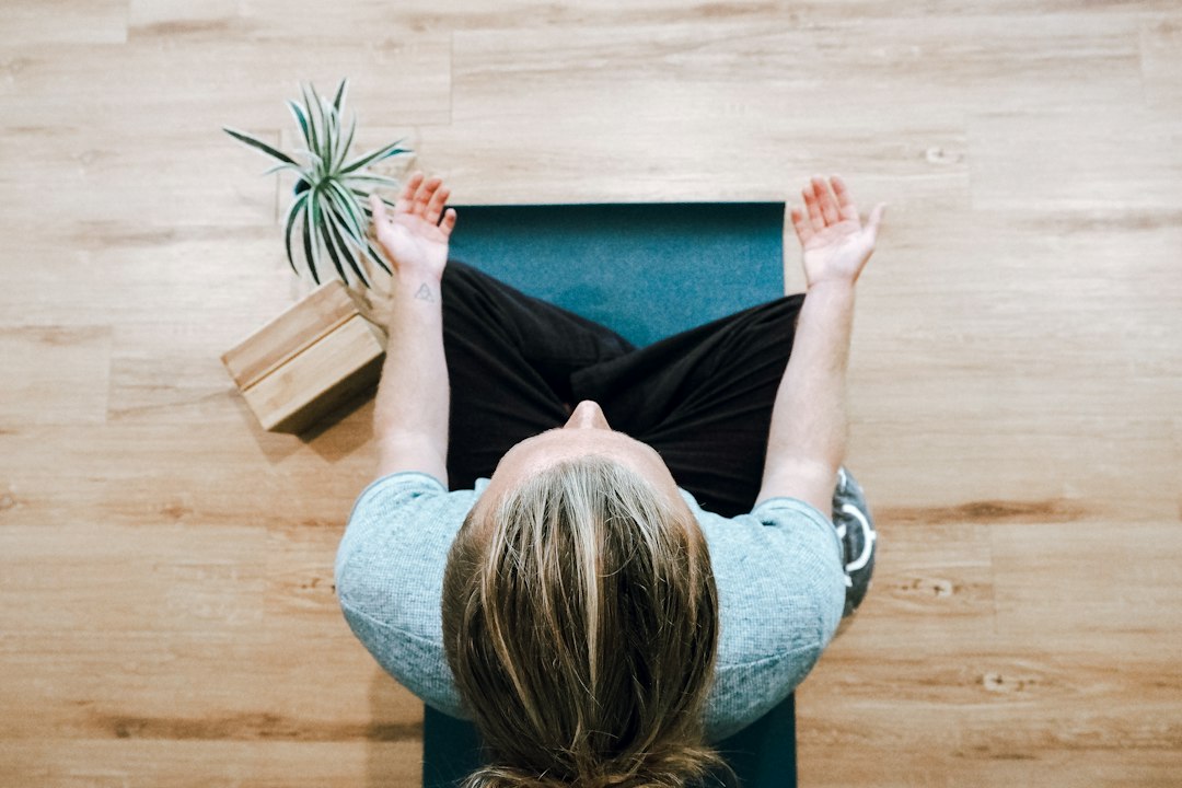Adult seated quietly in a reflective setting, illustrating relaxation, focused attention, and behavior-change practice.